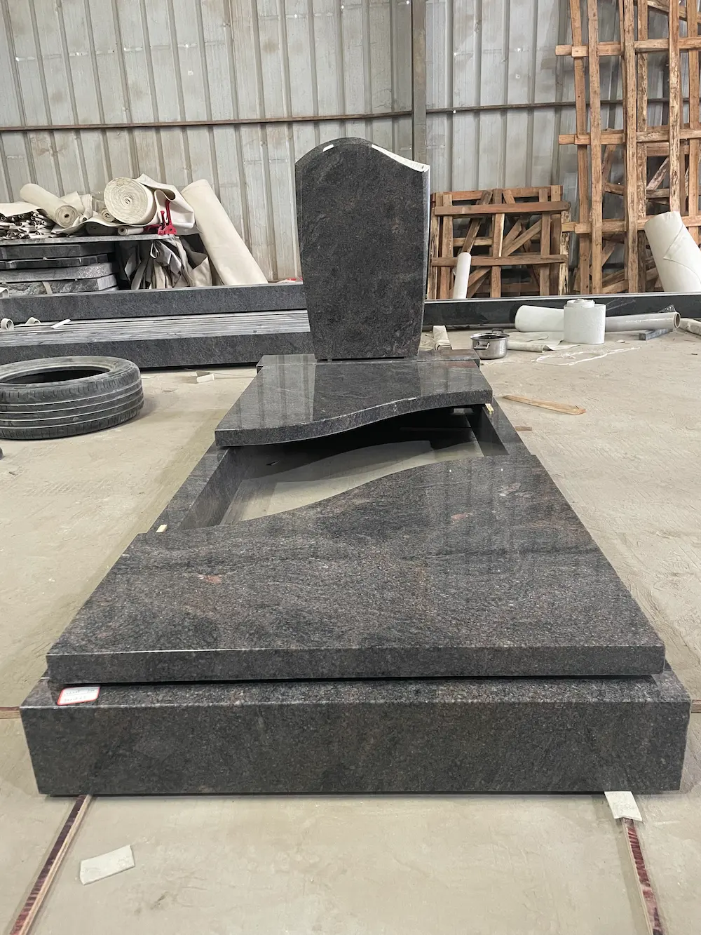 Himalaya Blue granite German-style full cover tombstone with curved headstone and raised base