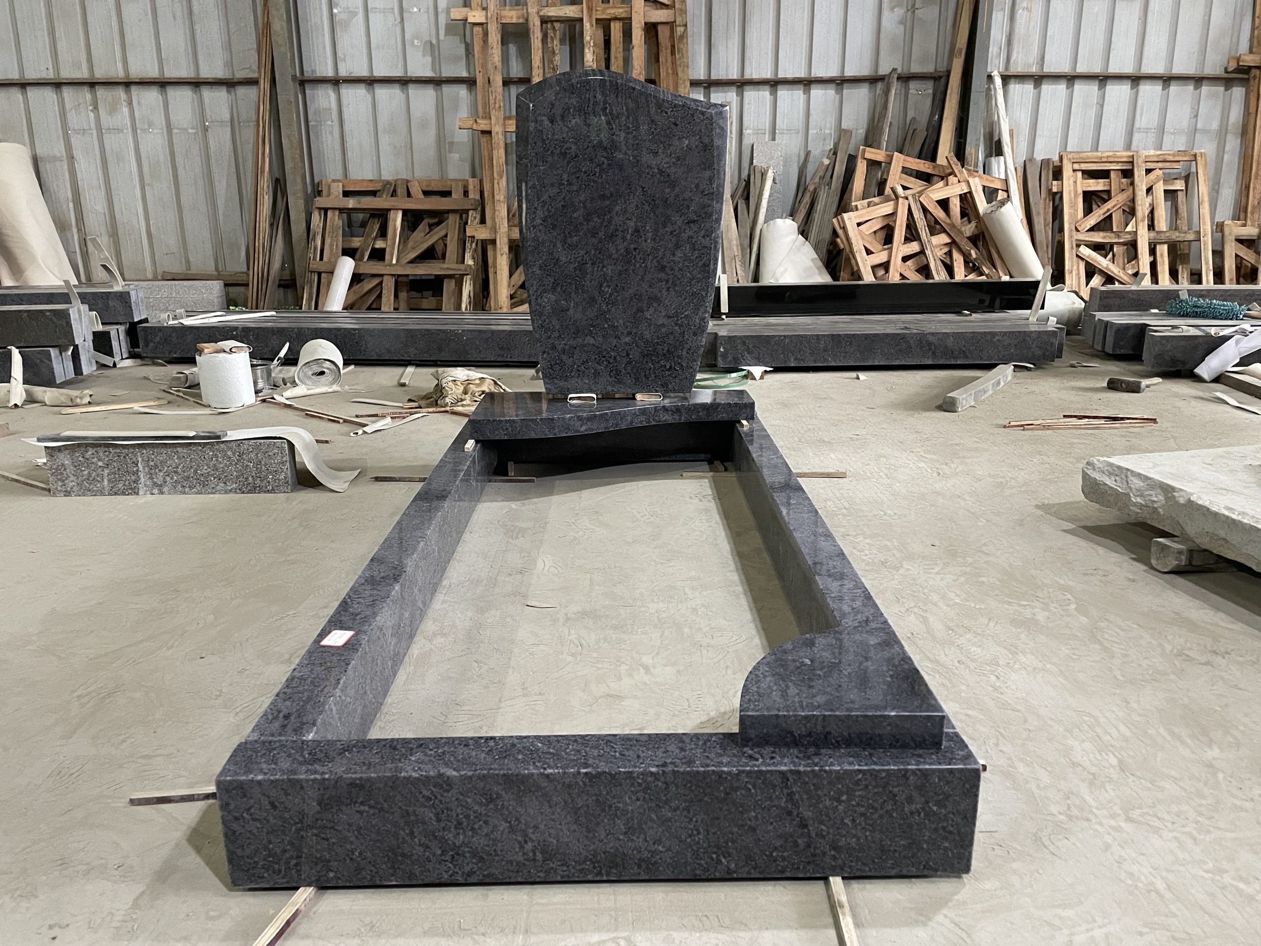 Bahama Blue granite German-style kerb memorial with curved upright headstone